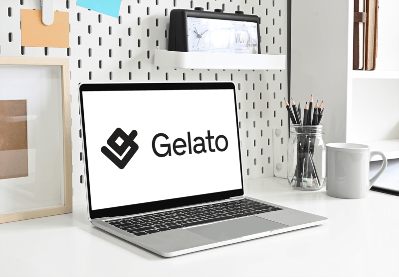 Mockup Of A Macbook On A Clean Office Desk Featuring Gelato's Logo