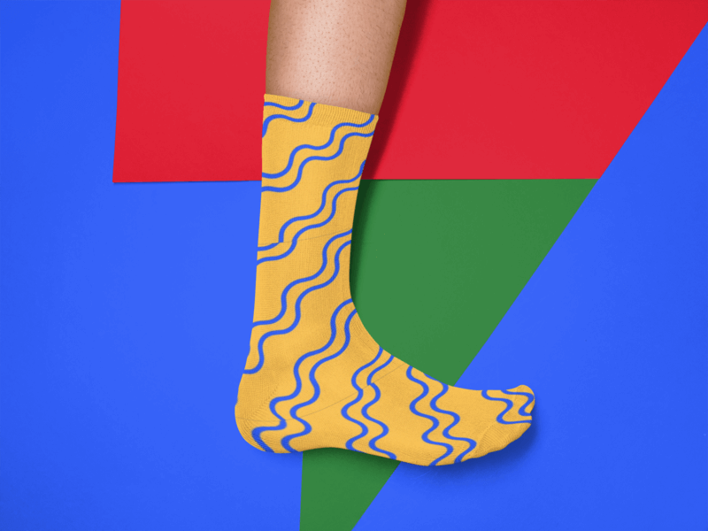 Mockup Of A Mans Foot Wearing A Sock Against A Tricolor Surface