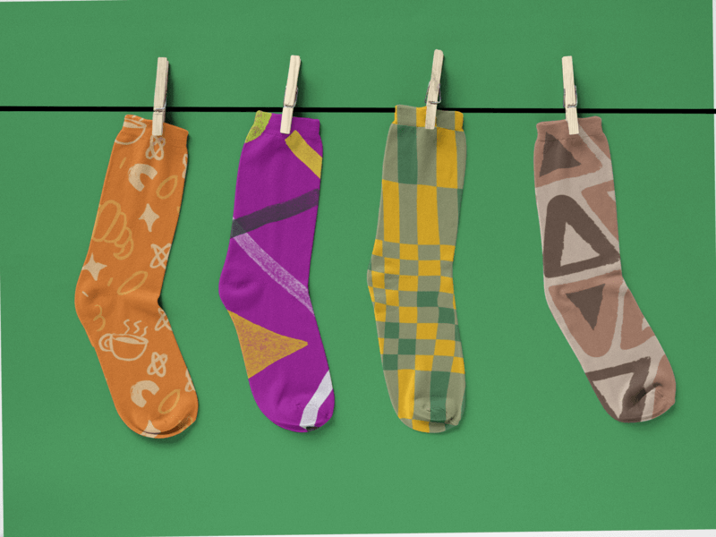 Two Pairs Of Socks Mockup Hanging From A Rope Against A Solid Backdrop