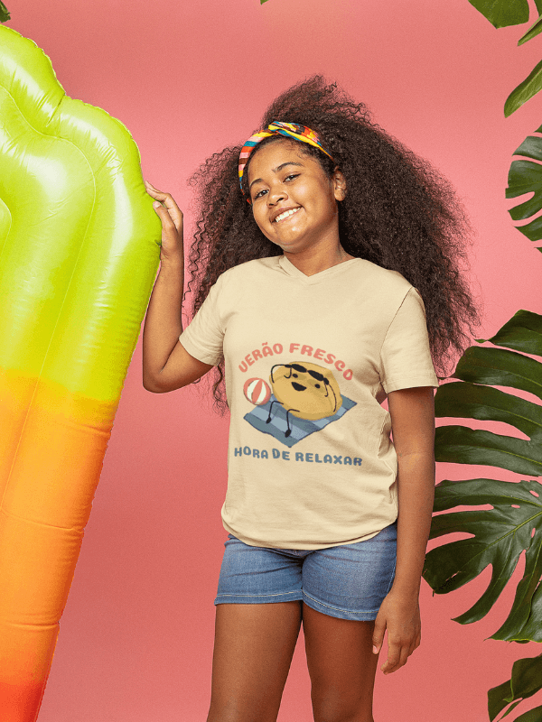 A Happy Girl Wearing A Summer T Shirt Featuring An Illustrated Character At The Beach