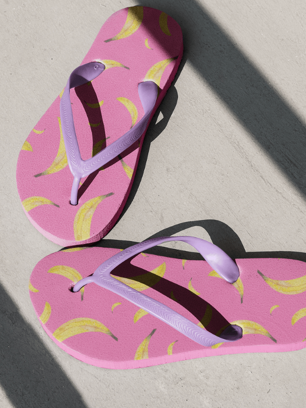 A Pair Of Pink Flip Flops Featuring A Fruit Pattern