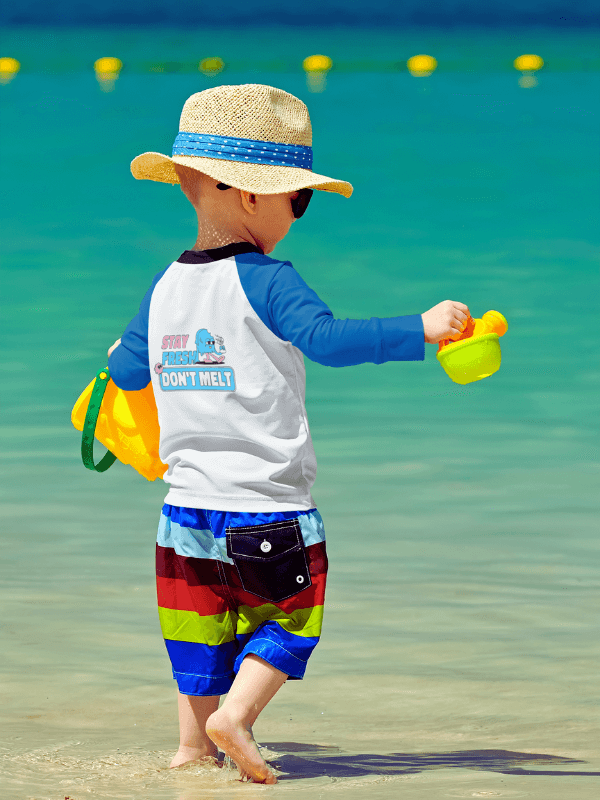A Toddler Wearing A Raglan Long Sleeve Tee By The Beach