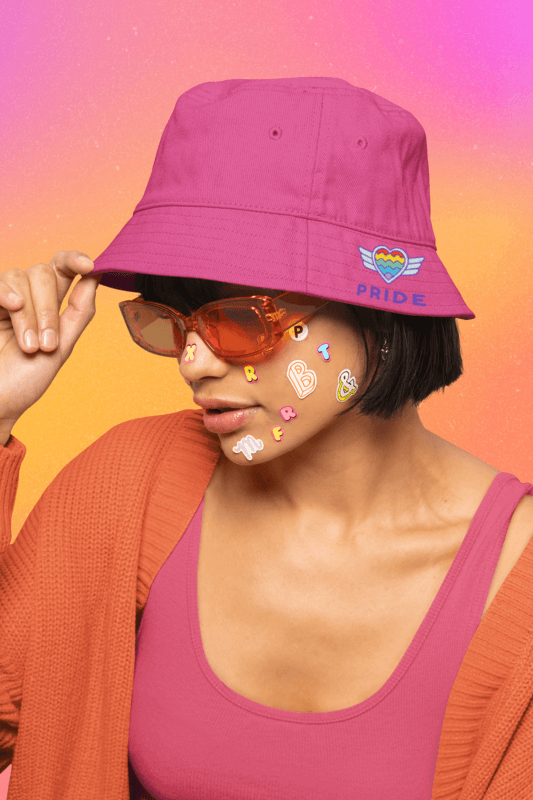Bucket Hat Mockup Featuring A Woman With Stickers On Her Face And A Pride Design