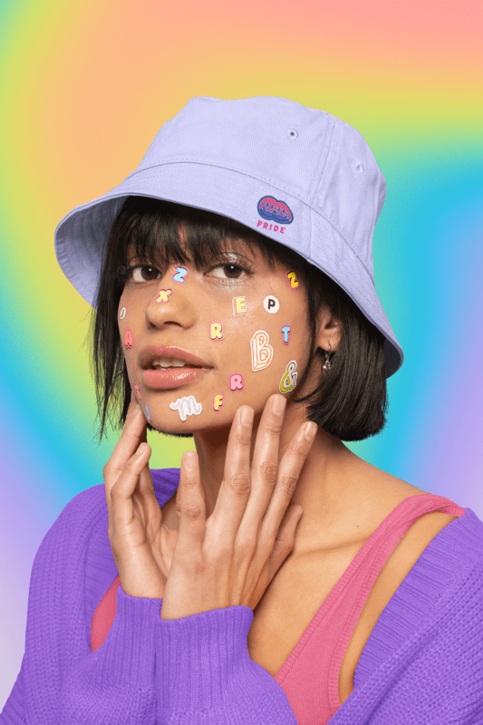 Bucket Hat Mockup Of A Woman With Colorful Letter Stickers On Her Face And A Pride Design