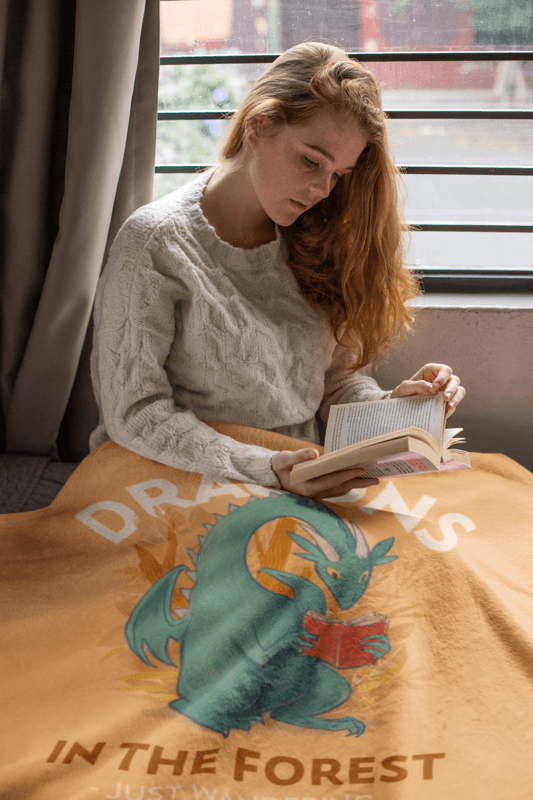 Fantasy Themed Fleece Blanket Mockup Featuring A Cozy Woman Reading A Book