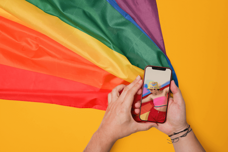 Mockup Of An Iphone 12 Pro Featuring An LGBTQ+ Pride Flag