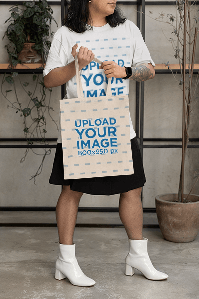 Sublimated Tote Bag Mockup Featuring A Cropped Face Tattooed Person In A T Shirt
