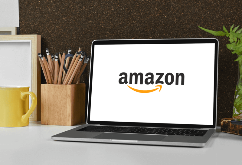 Mockup Featuring A Macbook Pro Featuring The Amazon Logoplaced On A Teacher's Desk