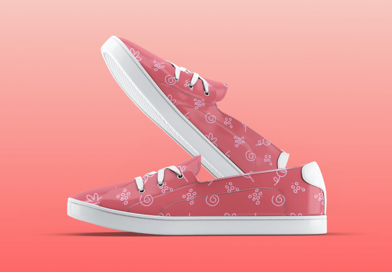 Mockup Of A Pair Of Sneakers With A Floral Pattern On A Customizable Surface