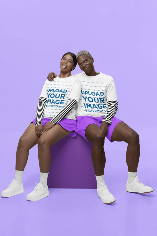 Stanley Stella T Shirt Mockup Featuring A Happy Man And Woman Sitting On Studio Against A Colorful Backdrop