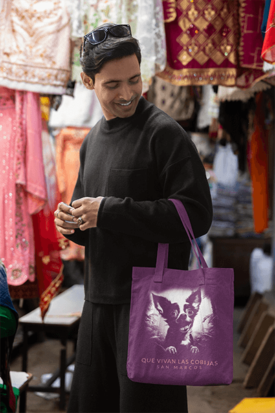 Tote Bag Mockup Featuring A Smiling Man Walking In A Street Market