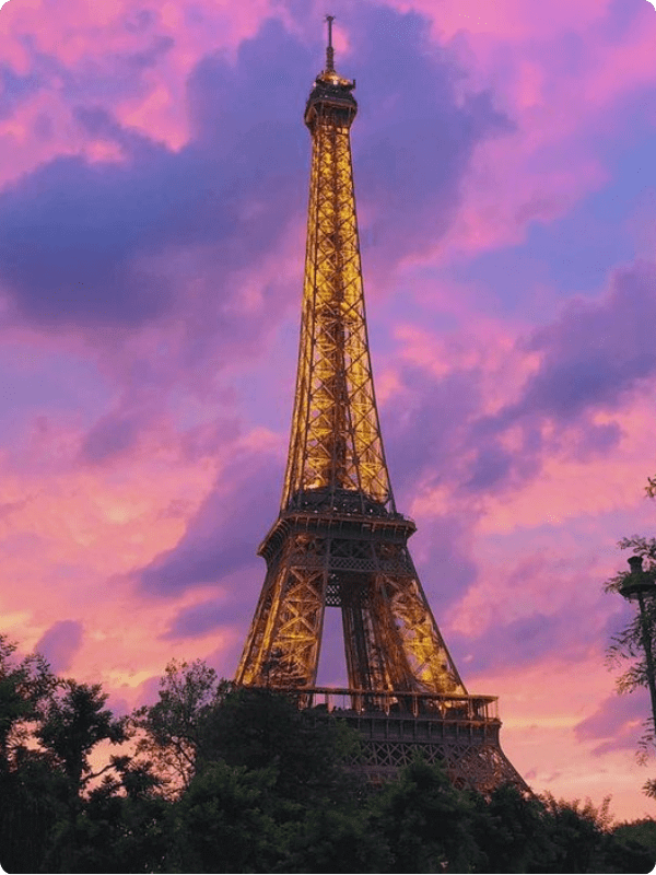 An Iconic View Of The Eiffel Tower On An Evening Night With Purple Skies