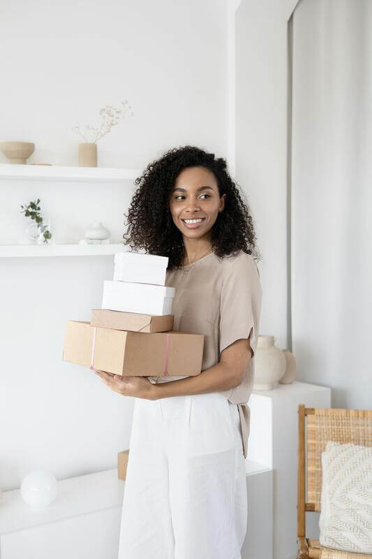 Photo Of A Woman Carrying Apparel Packaging By Pexels