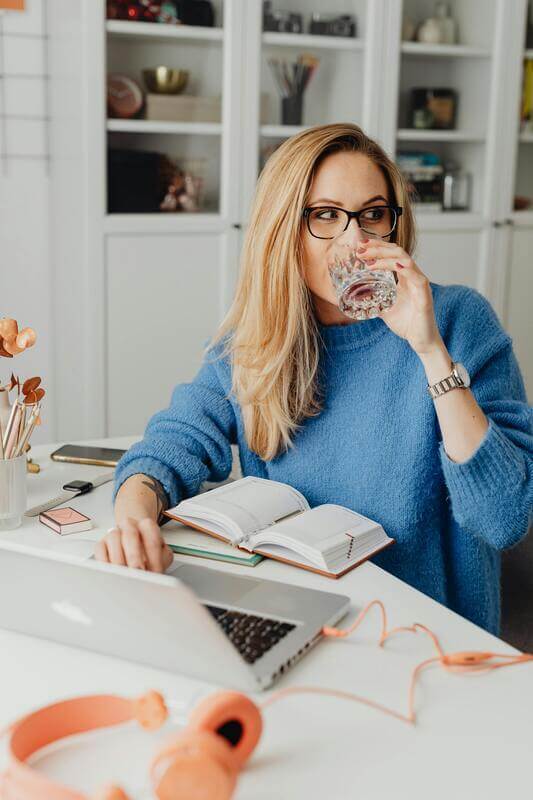 Photo Of A Woman Working On A Desk By Pexels