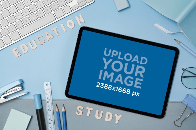 Product Mockup Of An iPad Surrounded By School Supplies Placed On A Blue Background