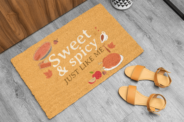 Cute Autumn Doormat Placed Next To A Pair Of Trainers