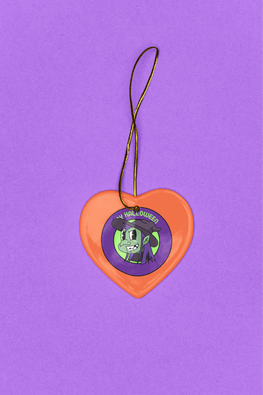 Mockup Of A Heart Shaped Halloween Themedceramic Ornament Lying In A Purple Background