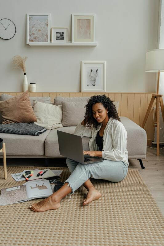 Photo Of A Woman Working On Her Laptop While Sitting On The Floor By Pexels