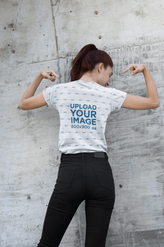 Back View V Neck T Shirt Mockup Of A Woman Raising Her Arms Against A Concrete Wall