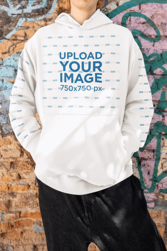 Hip Hop Inspired Mockup Of A Man Wearing An Oversized Hoodie In Front Of A Wall