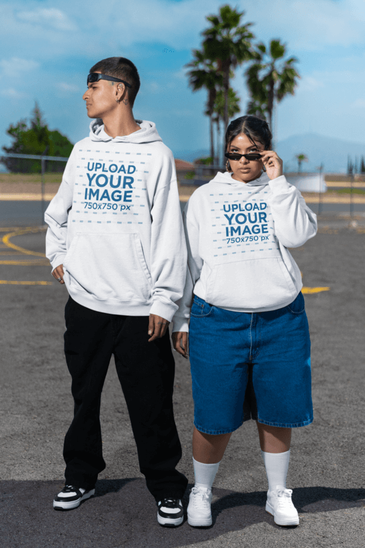 Hoodie Mockups Featuring A Man And A Woman In Matching Oversized Apparel