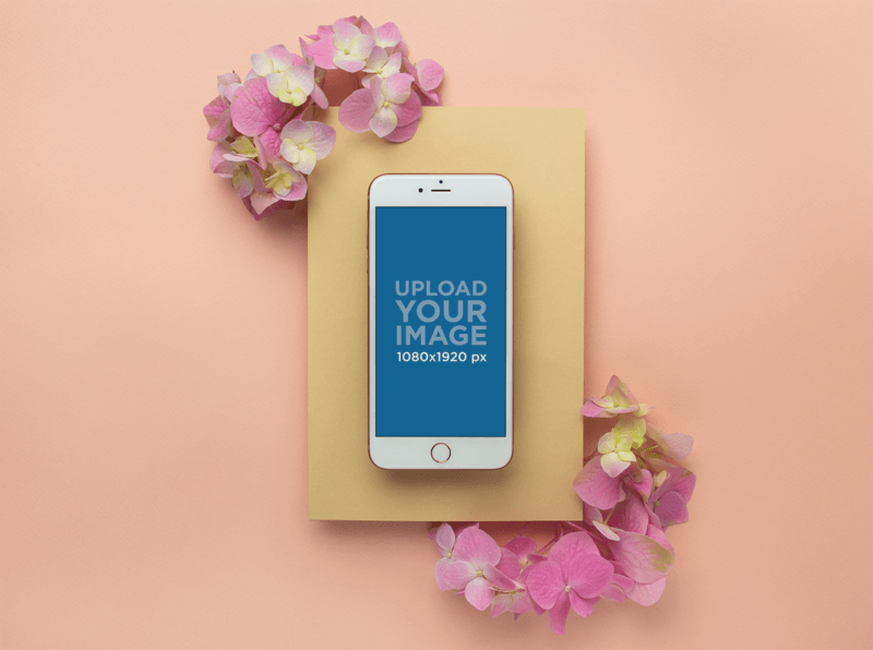 iPhone 8 Plus Mockup On A Yellow Cardboard With Pink Flowers For An App Promotion