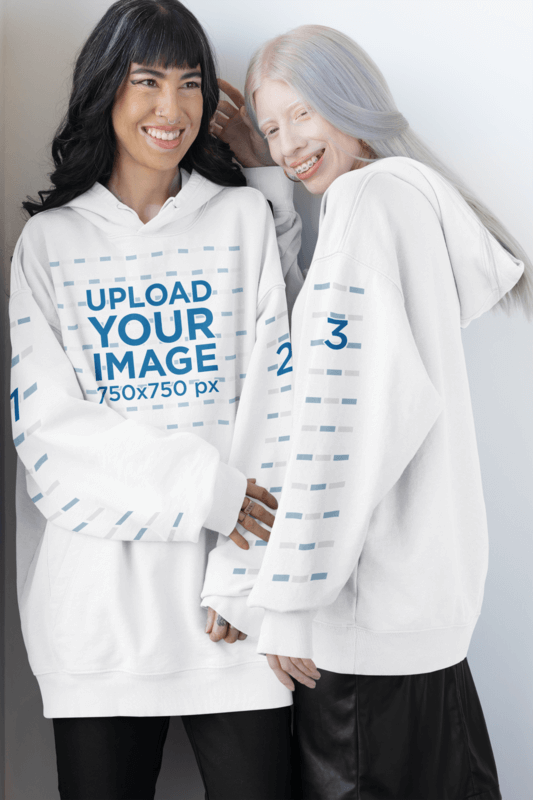 Oversized Pullover Hoodie Mockups Of Two Joyful Women Posing With Alternative Looks