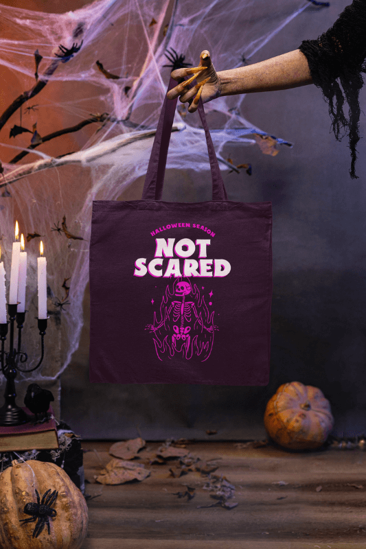 Halloween Inspired Mockup Featuring A Witch's Hand Holding A Tote Bag