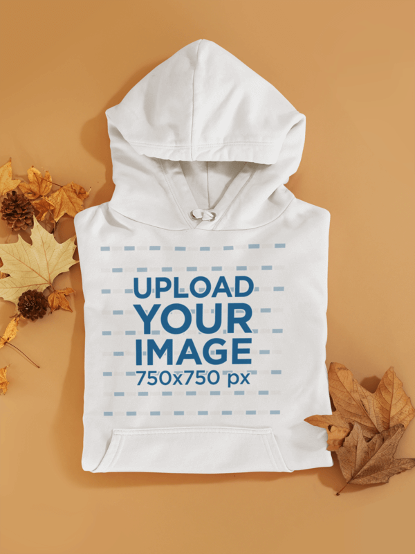 Mockup Of A Folded Hoodie Among Some Autumn Leaves