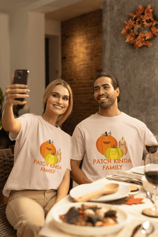 Stanley Stella T Shirt Mockup Of A Woman And A Man Posing Happily For A Selfie In A Thanksgiving Dinner