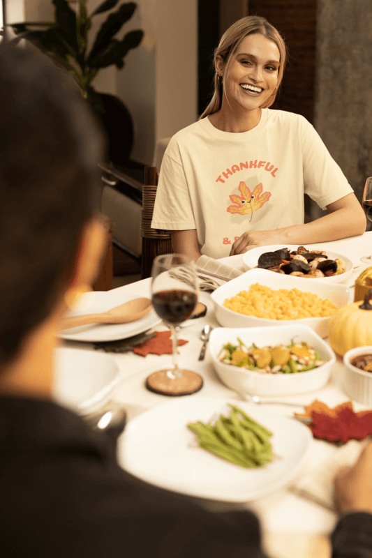 Stanley Stella Thanksgiving T Shirt Mockup Of A Woman Sitting At A Thanksgiving Decorated Table