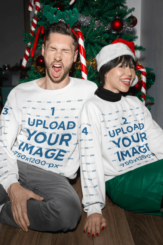 Gildan Sweatshirt Mockup Featuring A Joyful Couple Celebrating Christmas By A Decorated Tree