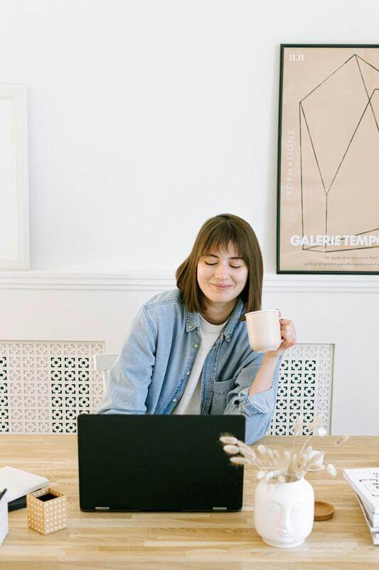 Photo Of A Woman Buying Online Holiding A Cup By Pexels