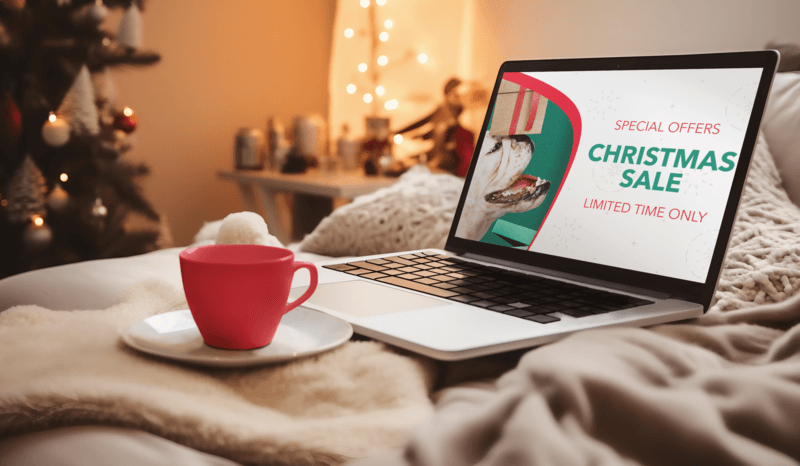 AI Generated Mockup Of A Macbook And A Coffee Mug Placed On A Winter Setting Showcasing A Christmas Promo