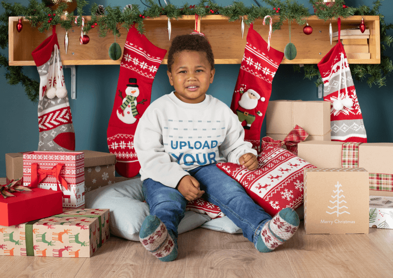 Mockup Of A Boy With A Crewneck Sweatshirt Surrounded By Christmas Presents