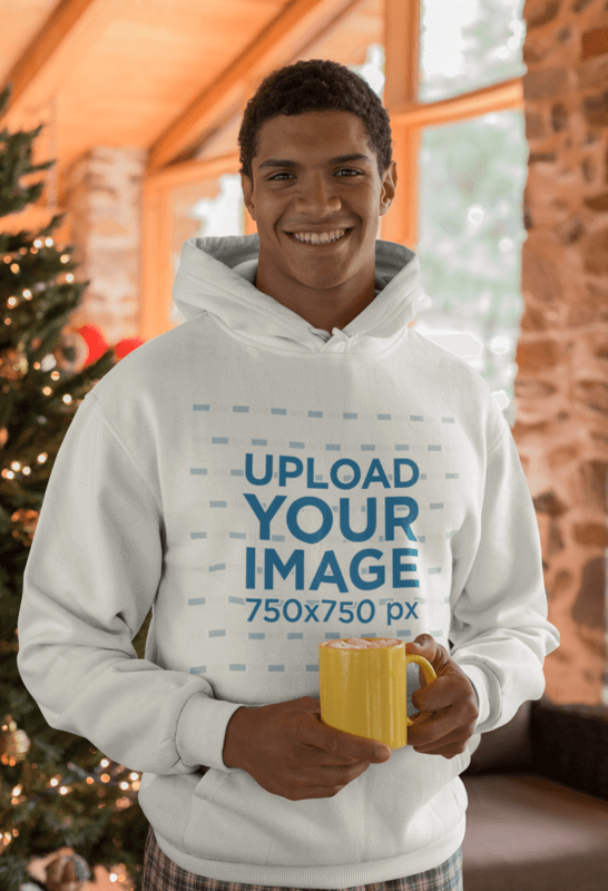 Mockup Of A Man Wearing A Hoodie In Front Of A Christmas Tree