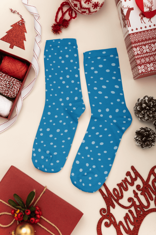 Mockup Of A Pair Of Socks Lying On A Christmas Decorated Surface