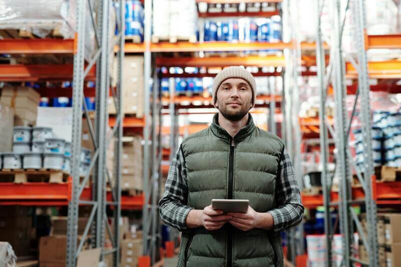 Photo Of A Man Wearing Winter Clothes Standing Inside A Warehouse By Pexels