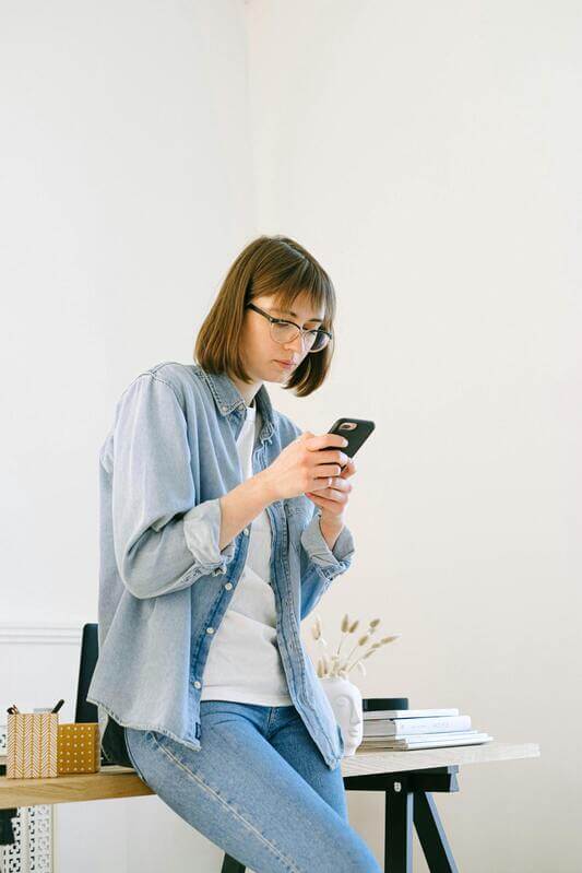 Photo Of A Woman Texting By Pexels