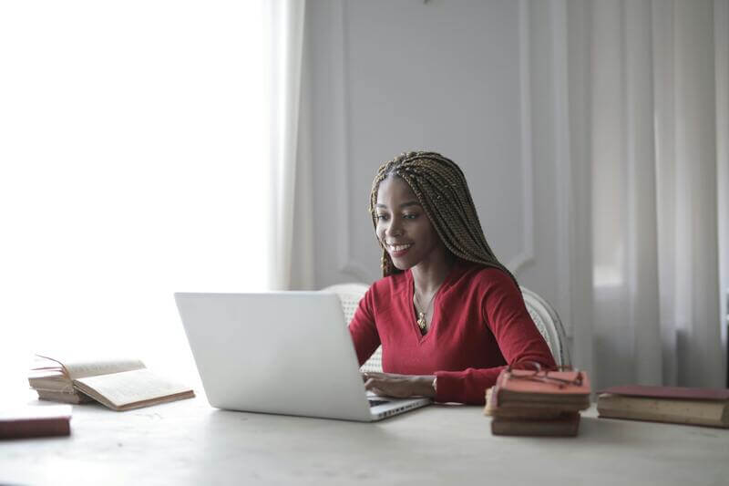 Photo Of A Woman Wearing A Long Sleeved Red Shirt Working On An Imac By Pexels