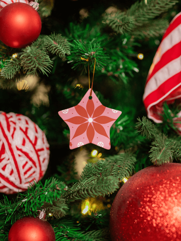 Print Mockup Of A Ceramic Star Shaped Ornament Placed On A Decorated Christmas Tree