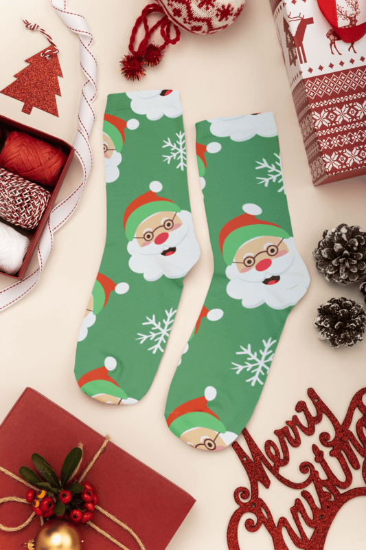 Mockup Of A Pair Of Socks With A Santa Print Pattern Lying On A Christmas Decorated Surface