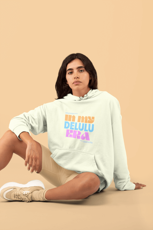 Monochromatic Sweatshirt Mockup Featuring A Woman Sitting In A Studio With A Delulu Design