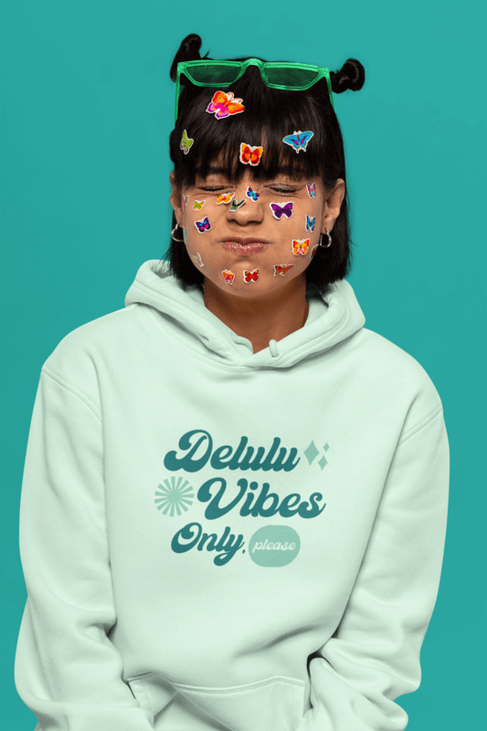 Pullover Hoodie Mockup Of A Woman With A Delulu Design And Skin Stickers Making A Funny Face