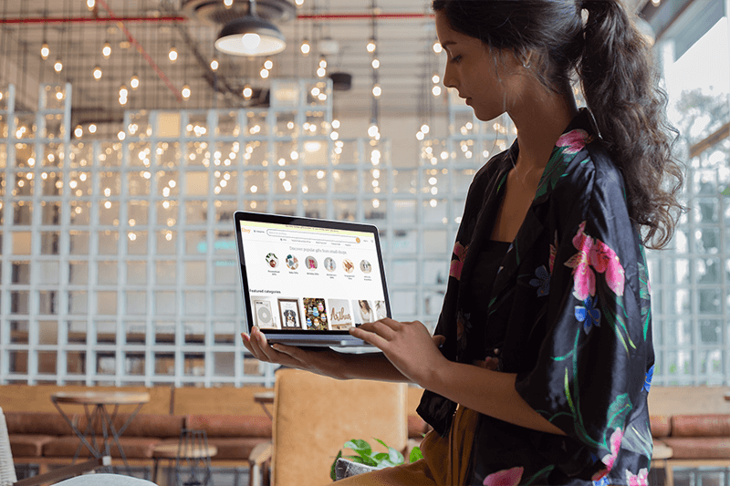 Woman Using A Macbook Mockup While Standing At A Startup