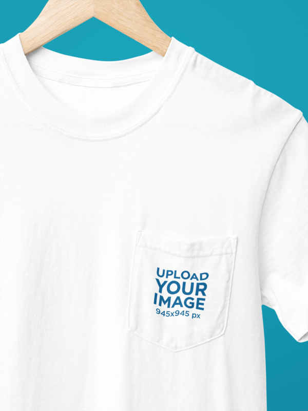 Mockup Of A Comfort Colors Pocket Tee Placed On A Hanger Featuring A Customizable Backdrop