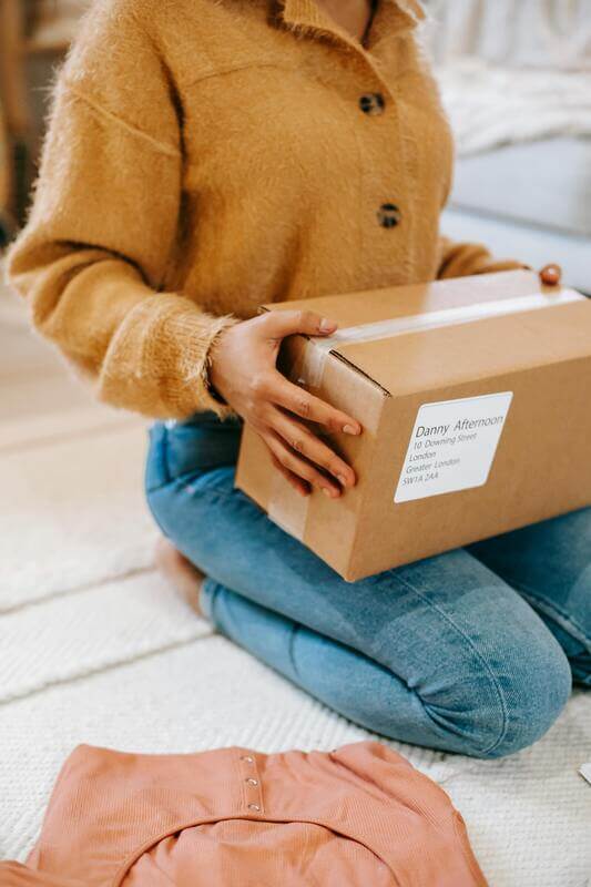 Photo Of A Woman Holding A Shipped Package By Pexels