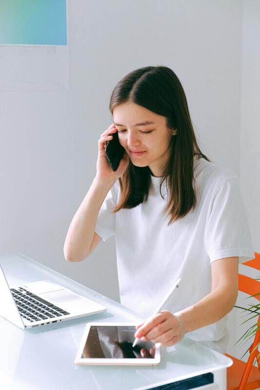 Photo Of A Woman Working On Her Laptop And Tablet By Pexels