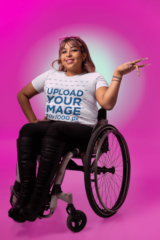 Blank Bella Canvas T Shirt Mockup Featuring A Smiling Woman On A Wheelchair Doing A Vogue Inspired Pose