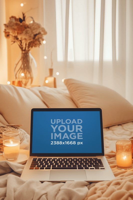 MacBook Pro Featuring A Cozy Setting With Candles And Flowers Created With Placeit's AI Mockup Generator